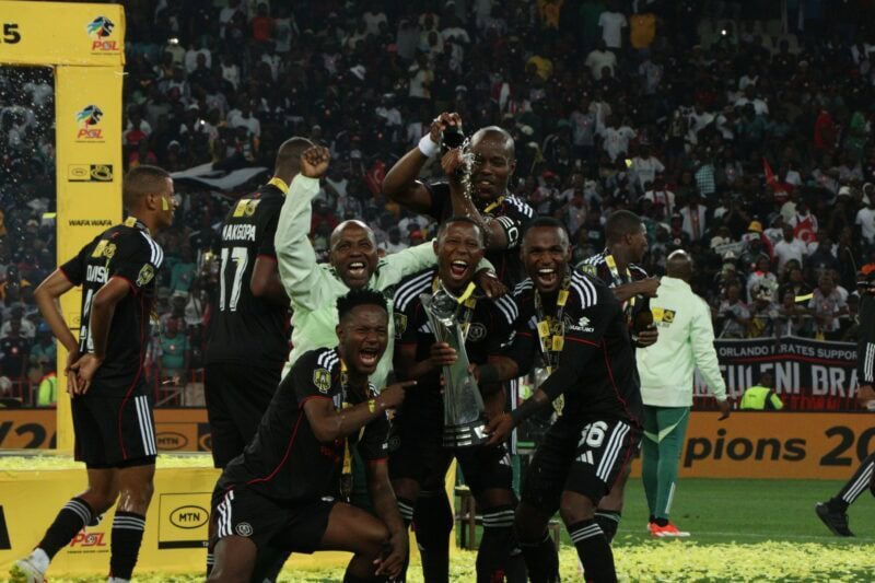 Orlando Pirates players enjoy the sweet taste of victory during the trophy handover ceremony. > Photo: Blake Linder
